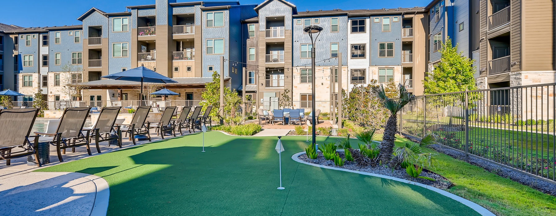 outdoor putting green adjacent to pool